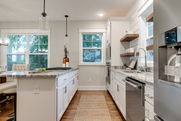 Beautiful, updated kitchen with white cabinetry and countertops