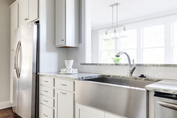 Kitchen with stainless farmhouse sink in renovated home built by Richmond Hill Design-Build