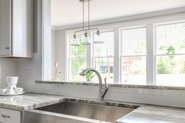 Kitchen with stainless farmhouse sink in renovated home built by Richmond Hill Design-Build