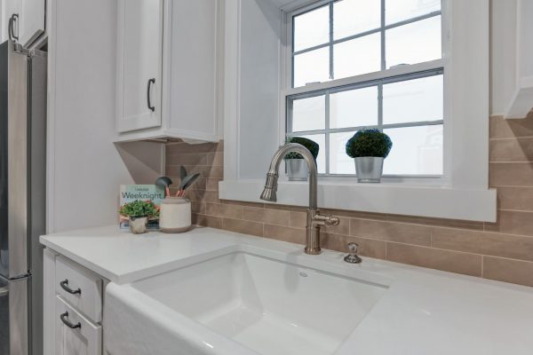 Porcelain farmhouse sink and subway tile backsplash in beautiful home by Richmond Hill Design-Build