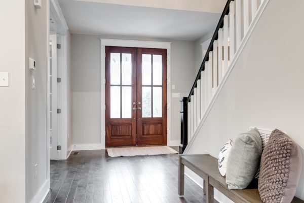 Entryway with double wood doors in new home built by Richmond Hill Design-Build