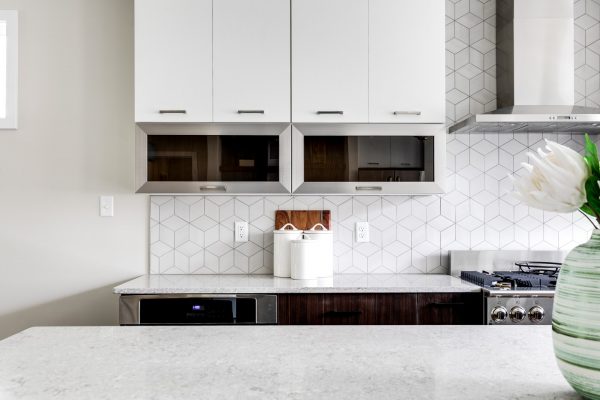 Stunning kitchen with white cabinetry in new contemporary home by Richmond Hill Design-Build