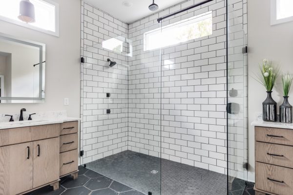 Gorgeous owner's bathroom with oversized shower in new contemporary home by Richmond Hill Design-Build