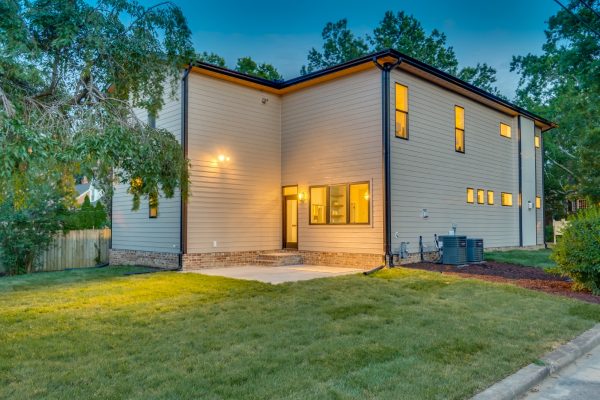 Stunning twilight photo of rear exterior of new contemporary home by Richmond Hill Design-Build