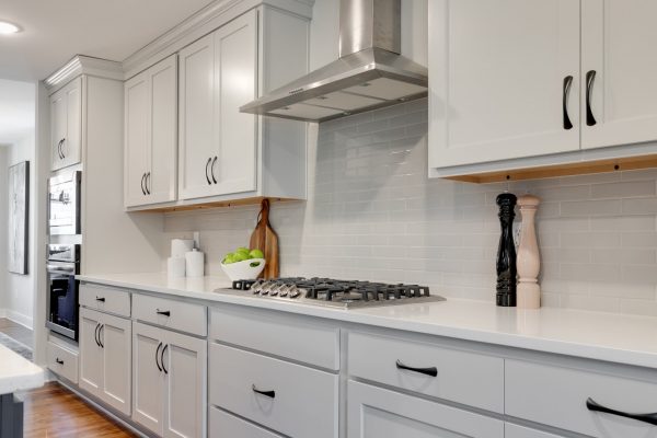 Cooktop and hood in kitchen of renovated home by Richmond Hill Design-Build