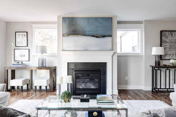 Family room with fireplace and built-ins in renovated home by Richmond Hill Design-Build