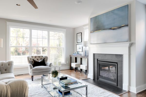 Family room with built-ins and fireplace in renovated home by Richmond Hill Design-Build