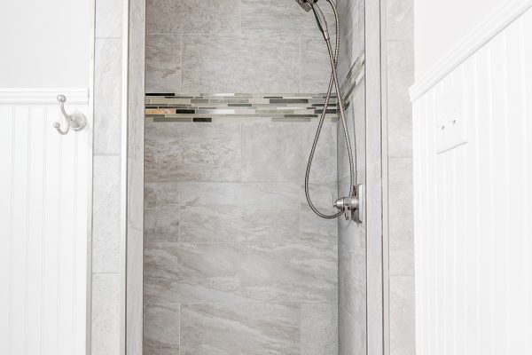 Shower in guest bathroom in renovated Dutch Colonial home by Richmond Hill Design-Build