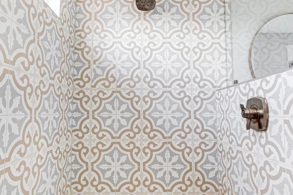 Beautiful tiled shower in owner's bathroom in renovated Dutch Colonial home by Richmond Hill Design-Build