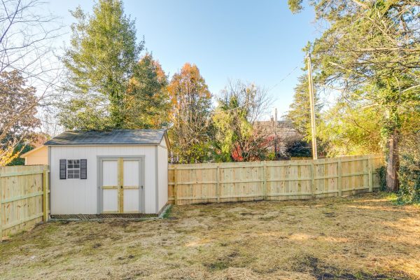 Rear yard with shed and fence of renovated Dutch Colonial home by Richmond Hill Design-Build