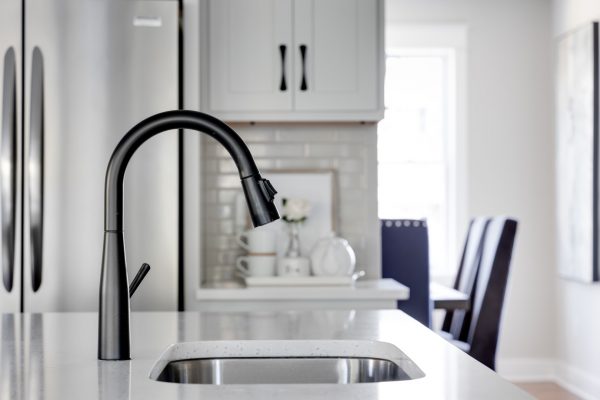 Kitchen faucet in island of renovated home by Richmond Hill Design-Build
