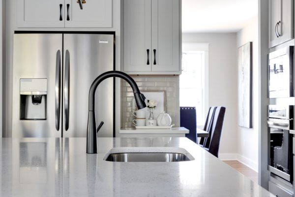 Kitchen faucet in island of renovated home by Richmond Hill Design-Build