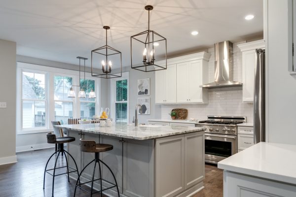 Kitchen with island and cage pendants in home built by Richmond Hill Design-Build