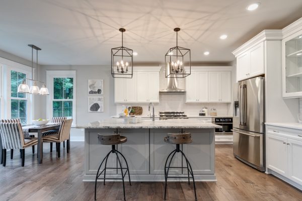 Kitchen with island and cage pendants in home built by Richmond Hill Design-Build