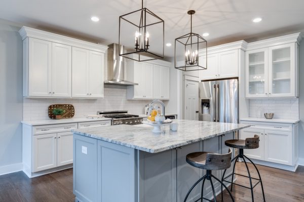 Kitchen with island and cage pendants in home built by Richmond Hill Design-Build