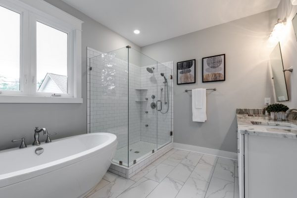 Beautiful owner's bathroom with corner shower in new home by Richmond Hill Design-Build