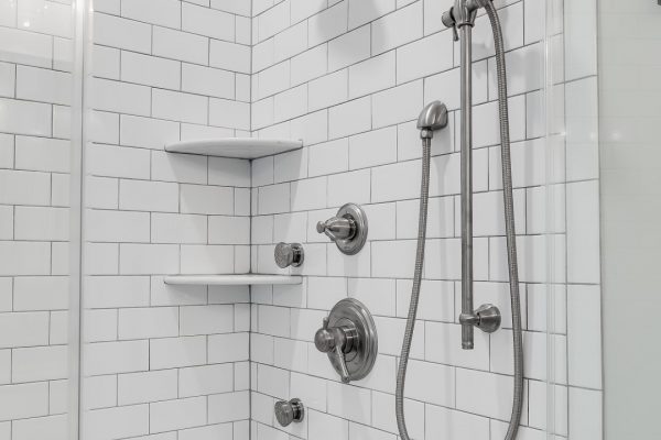 Subway tile shower in owner's bathroom in renovated home by Richmond Hill Design-Build