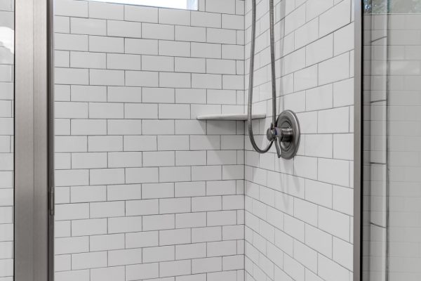 Shower with subway tile in renovated home by Richmond Hill Design-Build