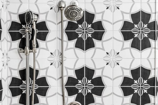 Vintage pattern tile in owner's shower in townhouse by Richmond Hill Design-Build