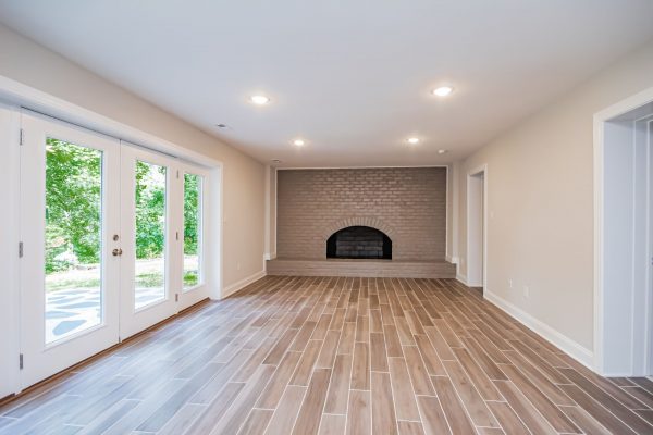 Rec room with fireplace in gorgeous renovated ranch home by Richmond Hill Design-Build