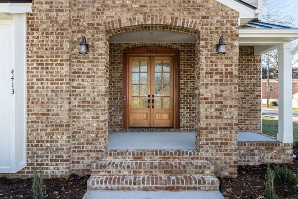 Brick front porch and double front doors of new home built by Richmond Hill Design-Build