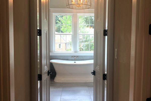 Primary bedroom view into bath in new home built by Richmond Hill Design-Build