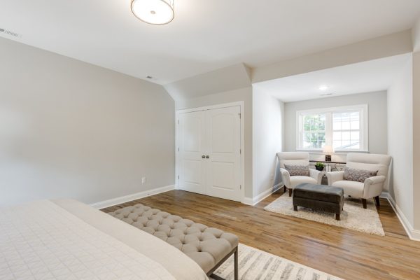 Owner's bedroom with sitting area in renovated home by Richmond Hill Design-Build