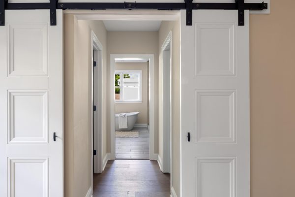 Hallway to primary bathroom of beautiful remodeled home by Richmond Hill Design-Build