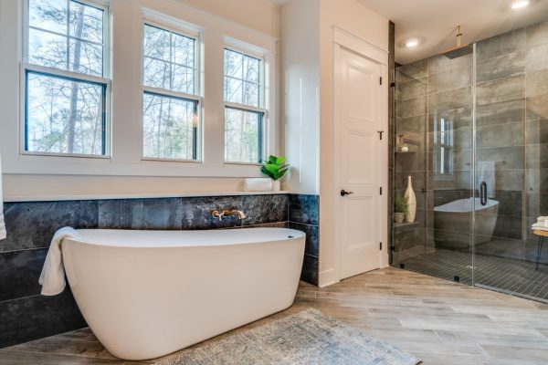 Freestanding tub in primary bathroom on first floor of new home built by Richmond Hill Design-Build