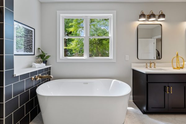 Freestanding tub in primary bathroom of remodeled home by Richmond Hill Design-Build