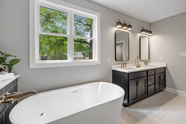 Freestanding tub in primary bathroom of remodeled home by Richmond Hill Design-Build