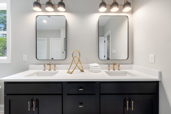 Double vanity in primary bathroom of remodeled home by Richmond Hill Design-Build