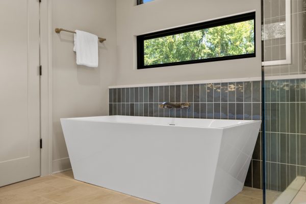Freestanding tub in primary bathroom in stunning new home built by Richmond Hill Design-Build